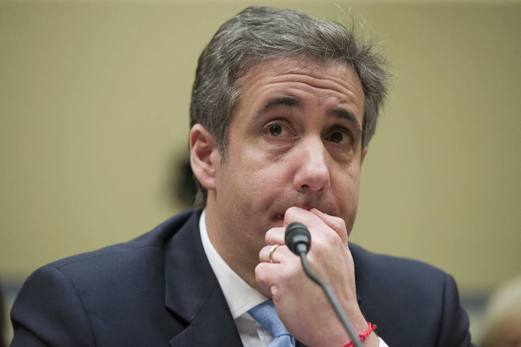 President Donald Trump's former personal lawyer Michael Cohen listens Feb. 27, 2019, to a quest ...
