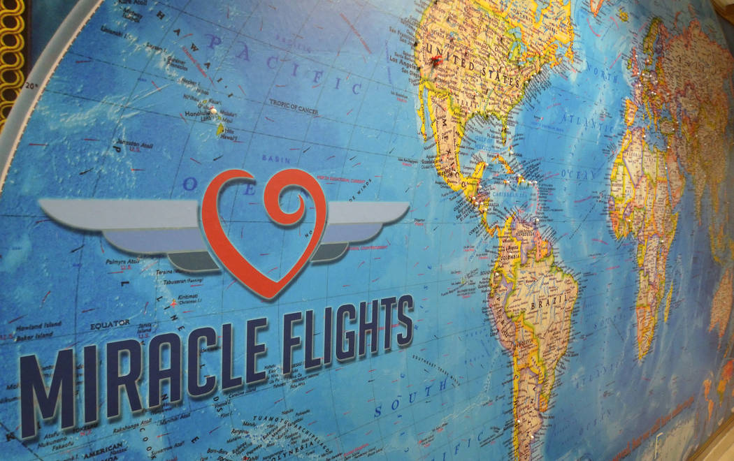 A map with pins showing locations Miracle Flights has traveled to is shown in the organization& ...