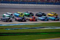 Aric Almirola (10) leads the pack as he wins Stage 1 during a NASCAR Cup Series auto race at Ta ...