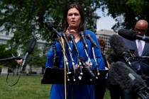 White House press secretary Sarah Sanders speaks with reporters outside the White House, Friday ...