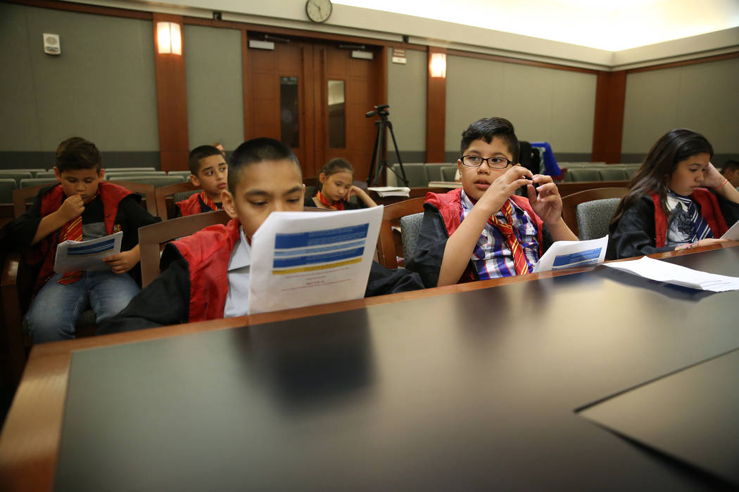 Playing as attorneys, Jaivian Gonzalez, 10, left, with Julianis Torres-Bermudez, 10, right, def ...