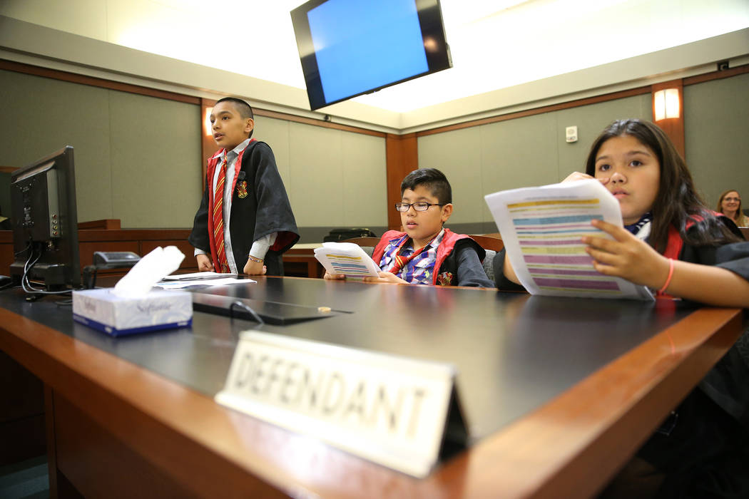 Playing as attorneys, Jaivian Gonzalez, 10, left, with Julianis Torres-Bermudez, 10, right, def ...