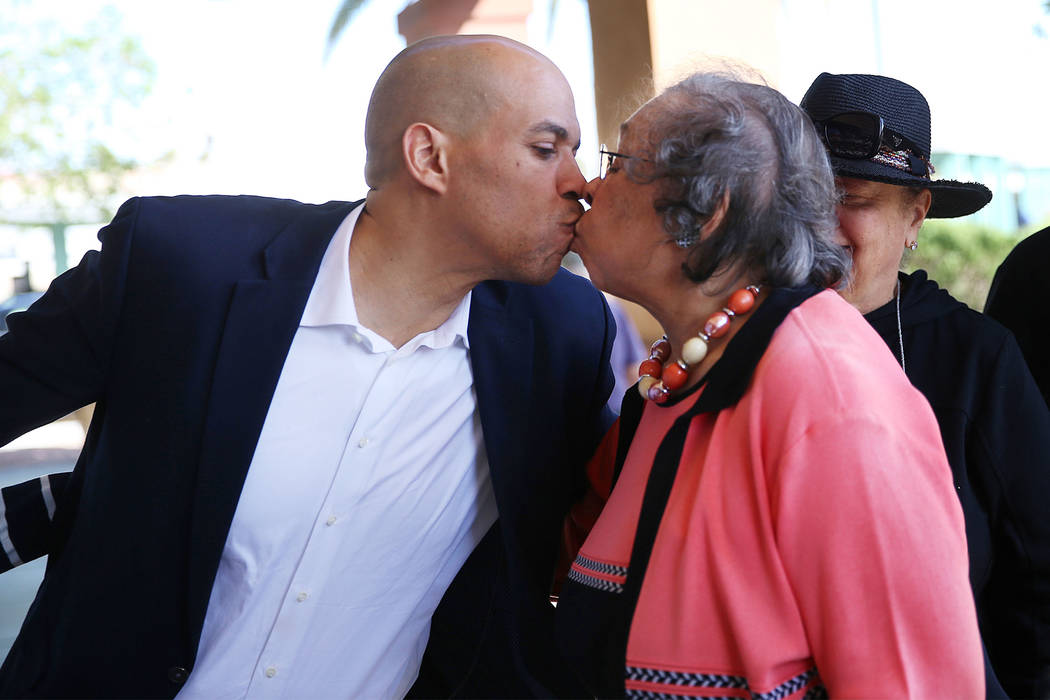 Democratic presidential candidate Sen. Cory Booker, left, kisses his mother Carolyn, following ...