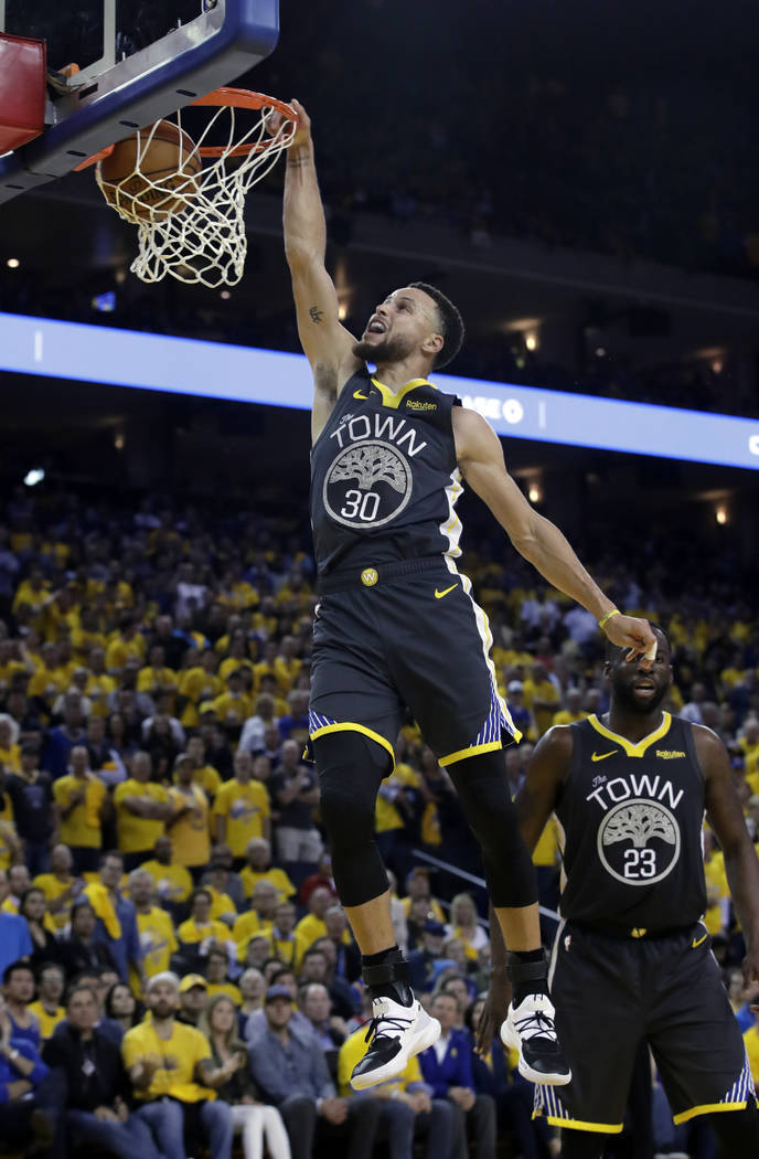 Golden State Warriors' Stephen Curry goes up for a dunk during the