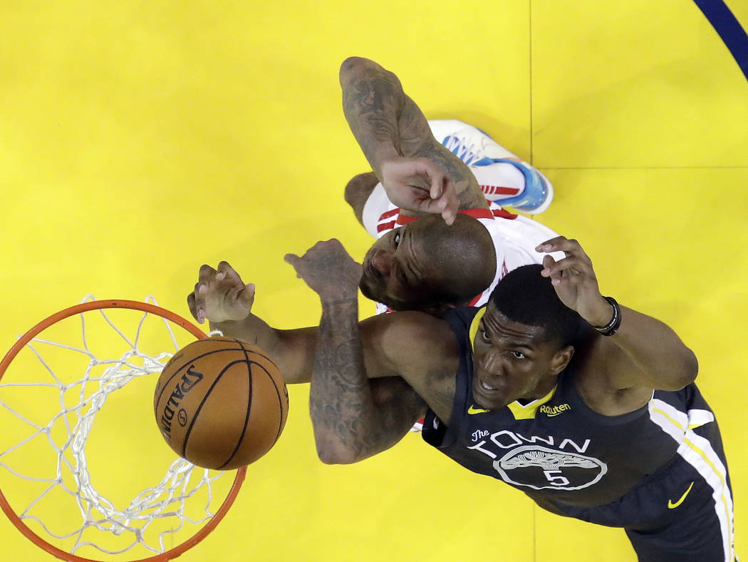 Golden State Warriors' Kevon Looney, bottom right, works for a rebound against Houston Rockets' ...