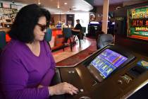 Lucille Brien plays a video poker machine at the Monte Bar and Casino in Billings, Montana, Tue ...