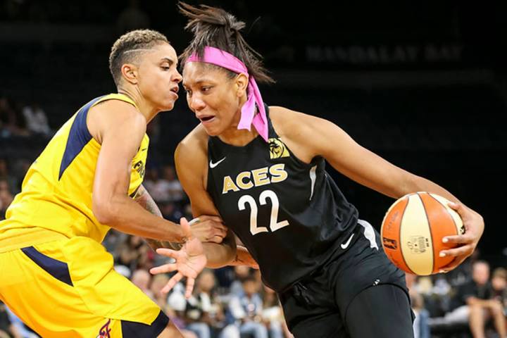 Las Vegas Aces center A'ja Wilson (22) drives the ball against Indiana Fever forward Candice Du ...