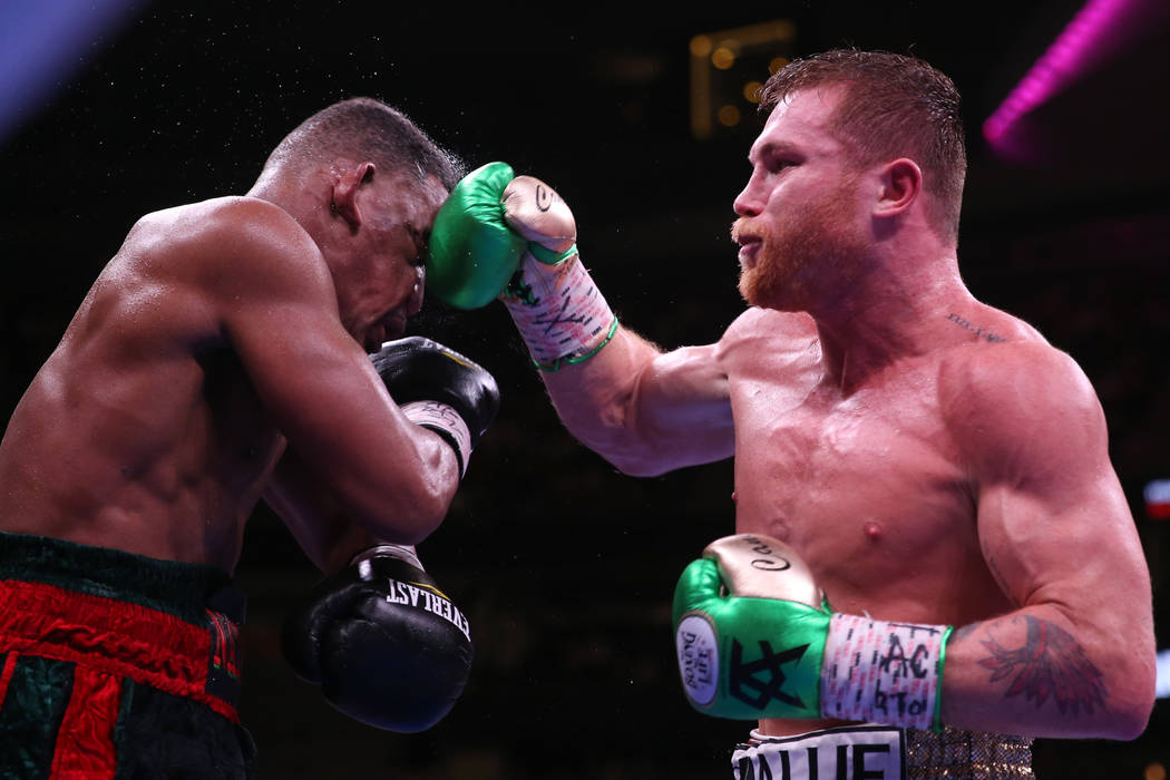 Saul “Canelo” Alvarez, right, connects a punch against Daniel Jacobs in the WBC, ...