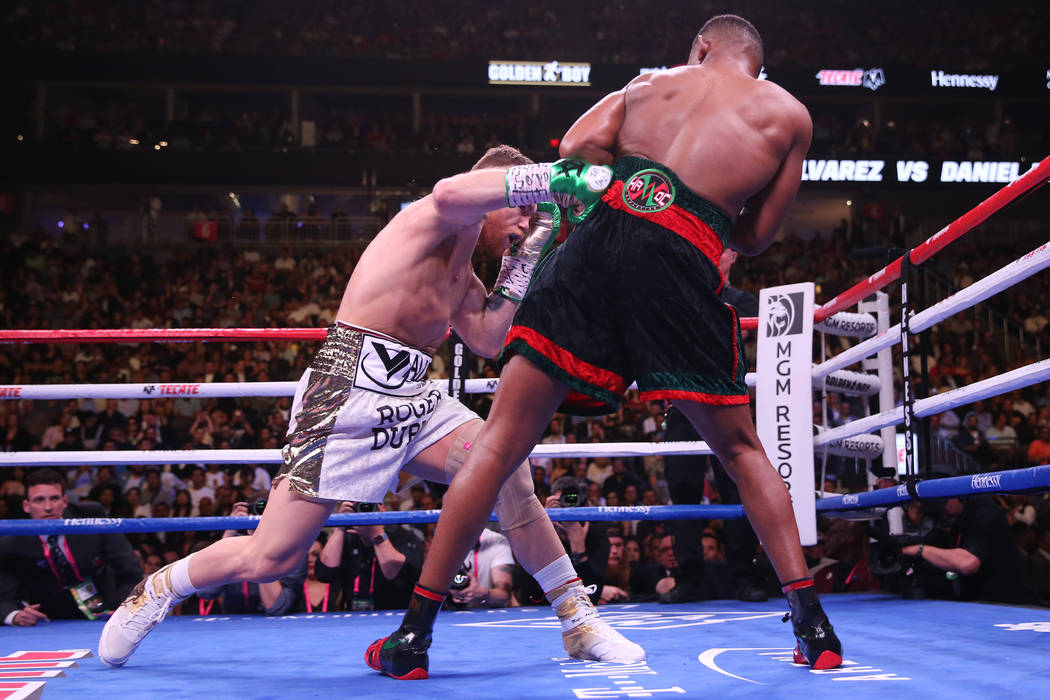 Saul "Canelo" Alvarez, left, connects a body shot against Daniel Jacobs in the WBC, W ...