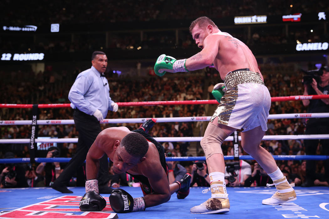 Daniel Jacobs, left, slips on the ring during the 12th round against Saul “Canelo&#x201d ...