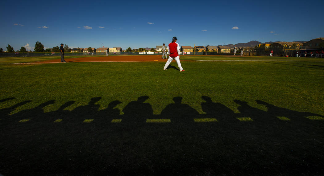 Spring Valley players are silhouetted behind Liberty head coach Rich Ebarb during the first rou ...