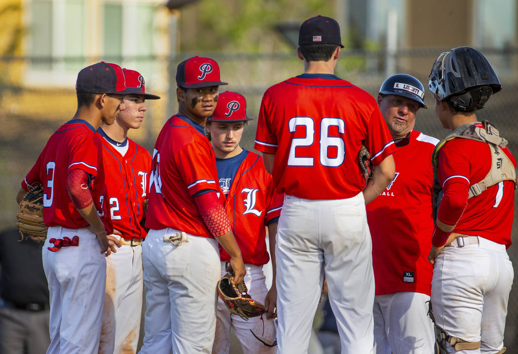 Liberty players come together with head coach Rich Ebarb for a time out versus Spring Valley du ...