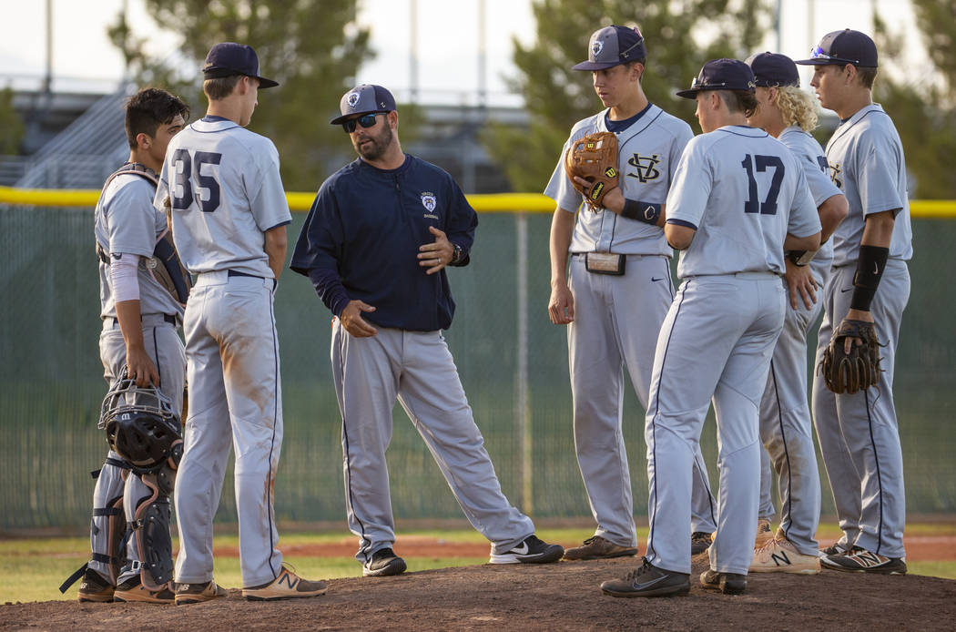 Spring Valley head coach Paul Bassett meets with his players during a time out versus Liberty i ...