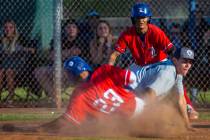 Liberty's Mason Bowden (1) looks on as teammate Ky Yamamoto (23) slides safely into home plate ...