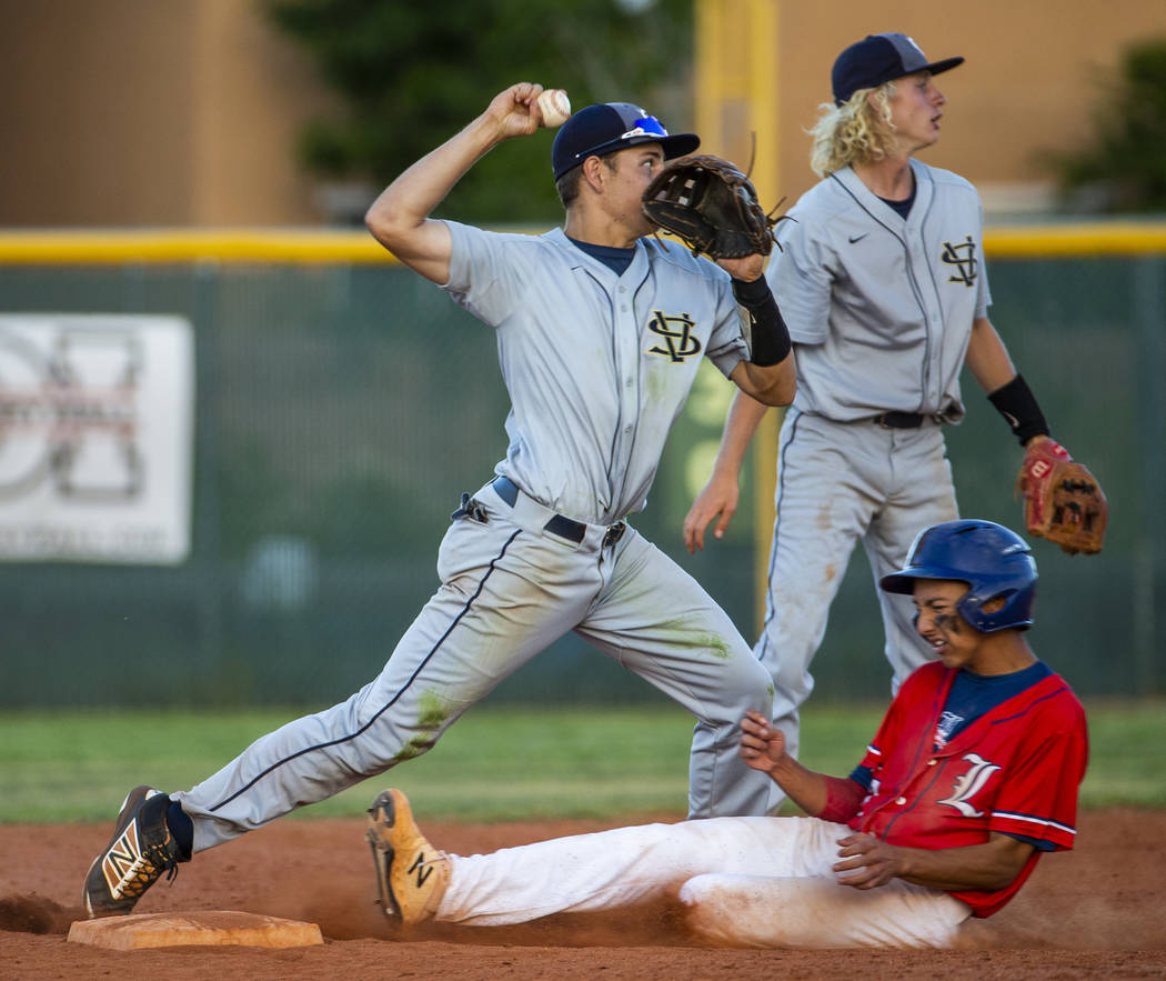 Spring Valley's (5, not on roster) makes the tag at second base as Liberty's Ryan Towers (14) ...