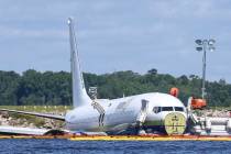 A charter plane carrying 143 people and traveling from Cuba to north Florida sits in a river at ...