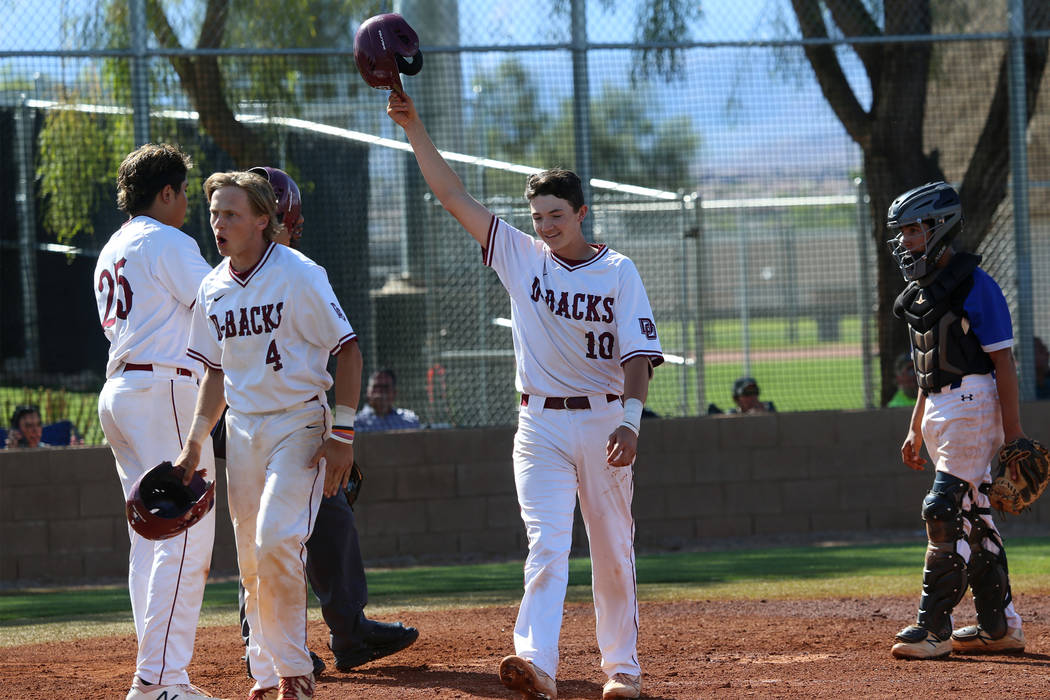 Desert Oasis' Colby Smith (10) reacts at home plate after hitting a two run home against Basic ...