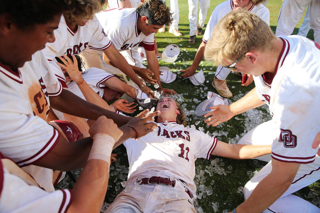 Desert Oasis' pitcher Josh Sharman (11) celebrates a win with his team over Basic in the Desert ...