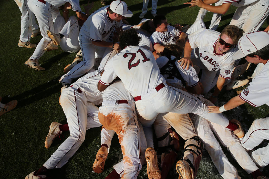 Desert Oasis celebrate their win over Basic in the Desert Region championship baseball game at ...