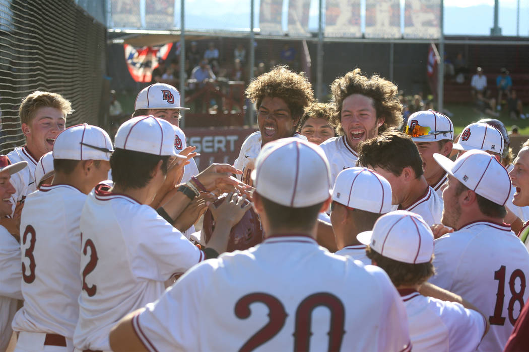 Desert Oasis celebrate a two run homer by Campbell Holt (16) against Basic in the Desert Region ...