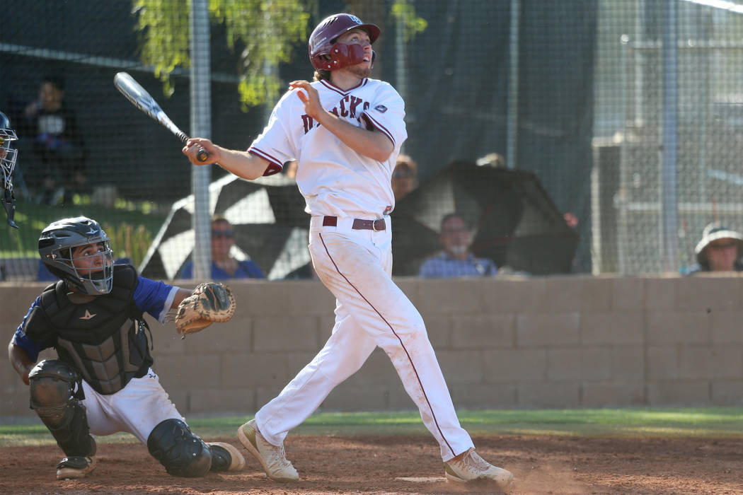 Desert Oasis' Campbell Holt (15) watches the ball leave for a solo homer against Basic in the D ...