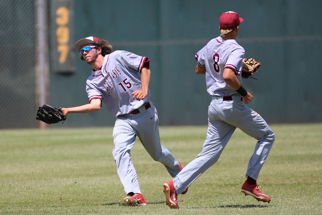 Desert Oasis' Campbell Holt (15) makes a catch in the outfield for an out against Las Vegas as ...