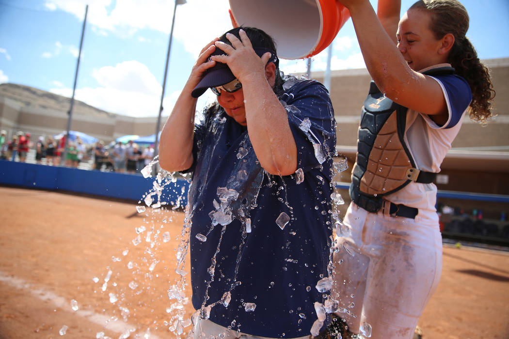 Shadow Ridge's Caitlyn Covington (3) dumps a bucket of ice water on head coach Julia Meyn after ...