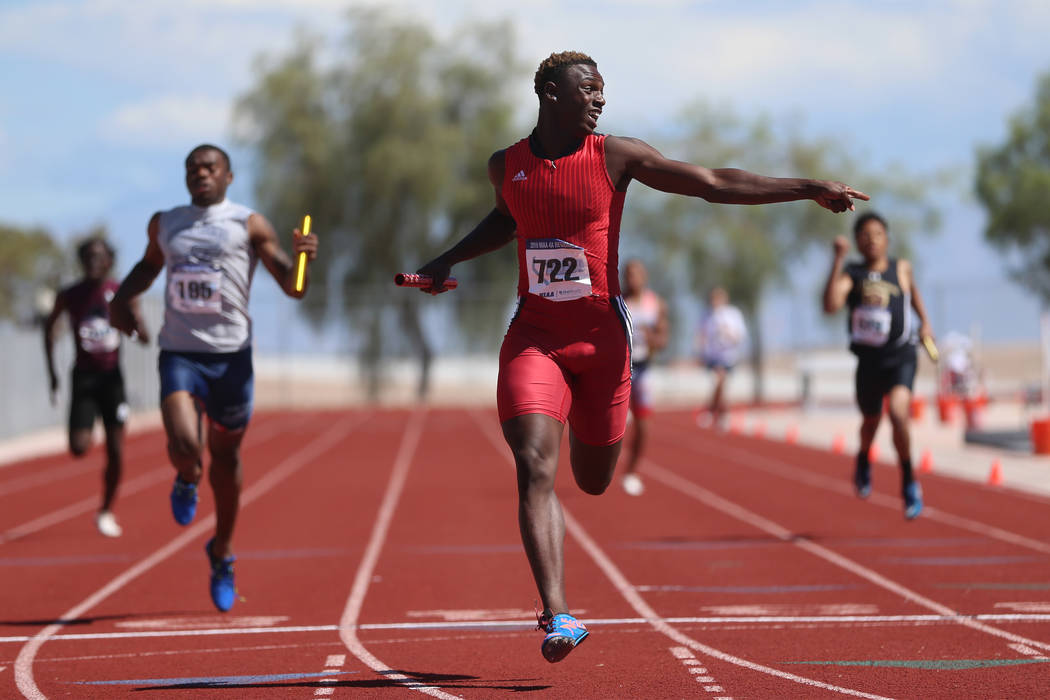 Las Vegas' Miles Davis (722) runs for first place in the Mountain Region boys 4x200 meter relay ...