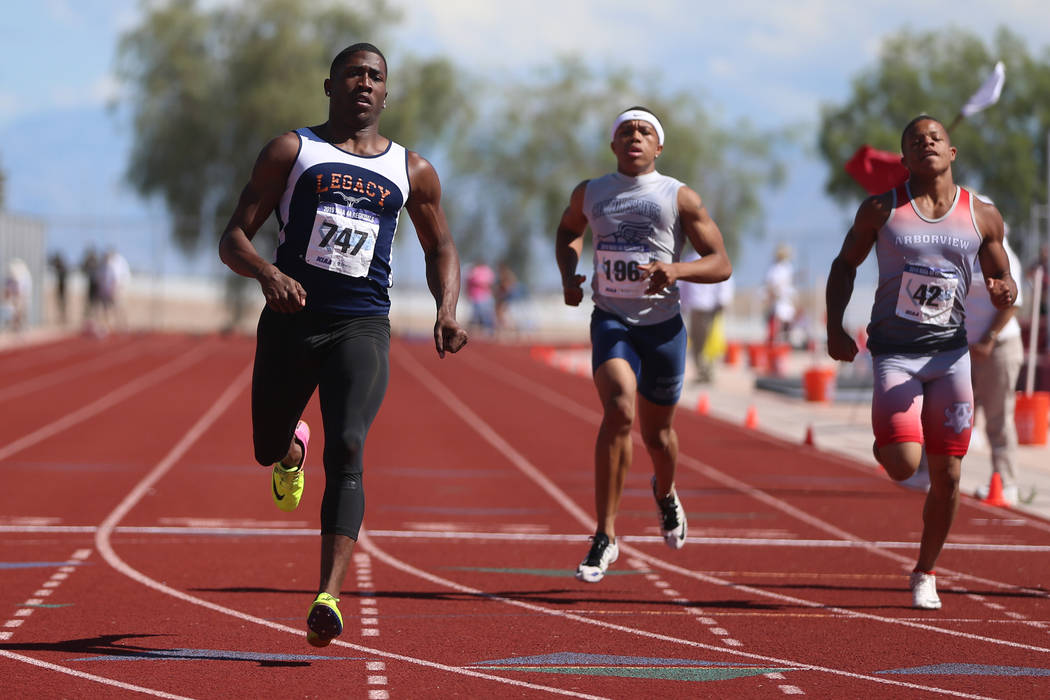 Legacy's Jerry Martin (747), from left, runs for first place, with Canyon Springs Isaiah Hayden ...