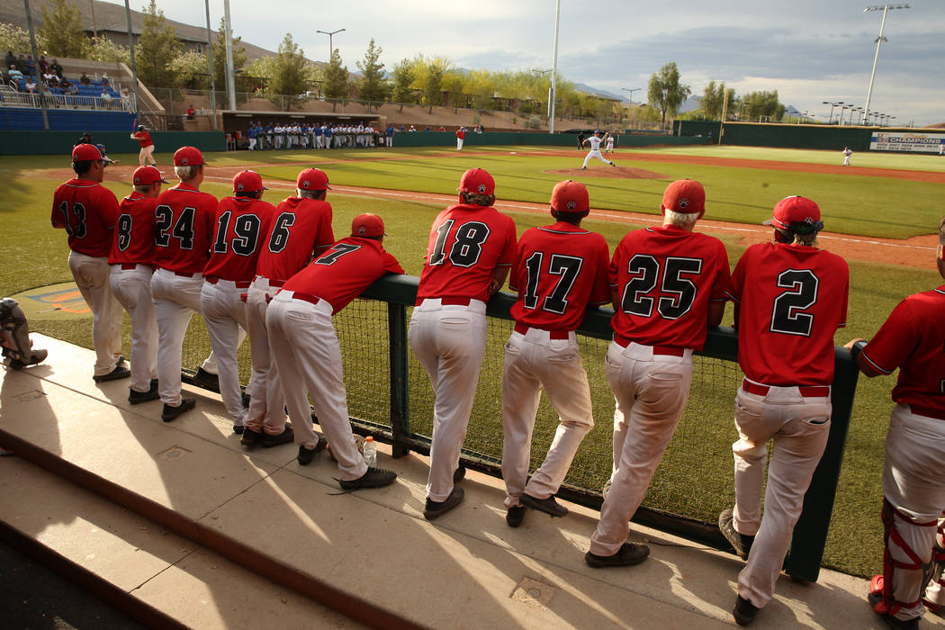 Las Vegas players cheer teammates from the dugout versus Reno during their state baseball tour ...