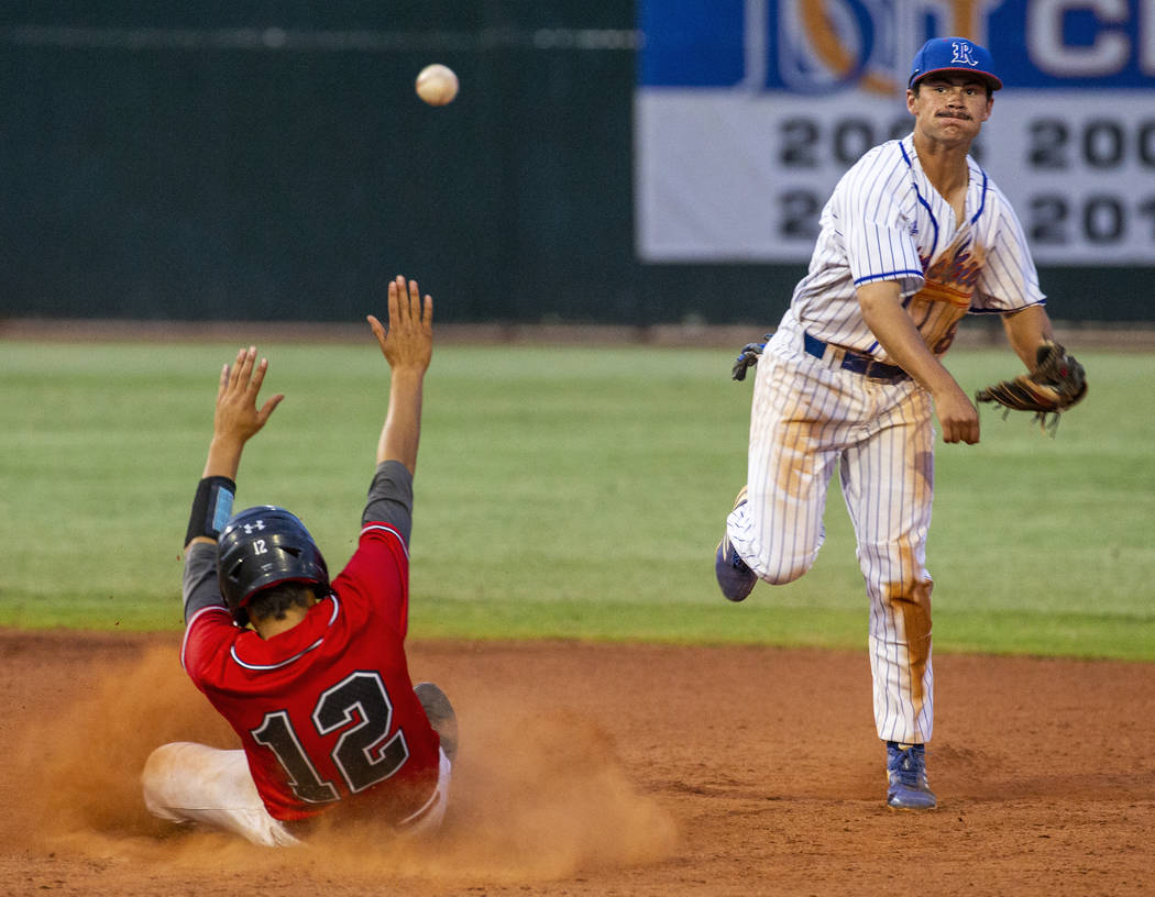 Las Vegas' Nathan Freimuth (12) slides late into second base as Reno's Gunner Gouldsmith (8) lo ...