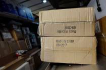 FILE- In this May 9, 2017, file photo packages labeled "Made in China" are loaded on ...