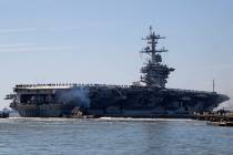 The USS Abraham Lincoln deploys from Naval Station Norfolk, in the vicinity of Norfolk, Va., in ...
