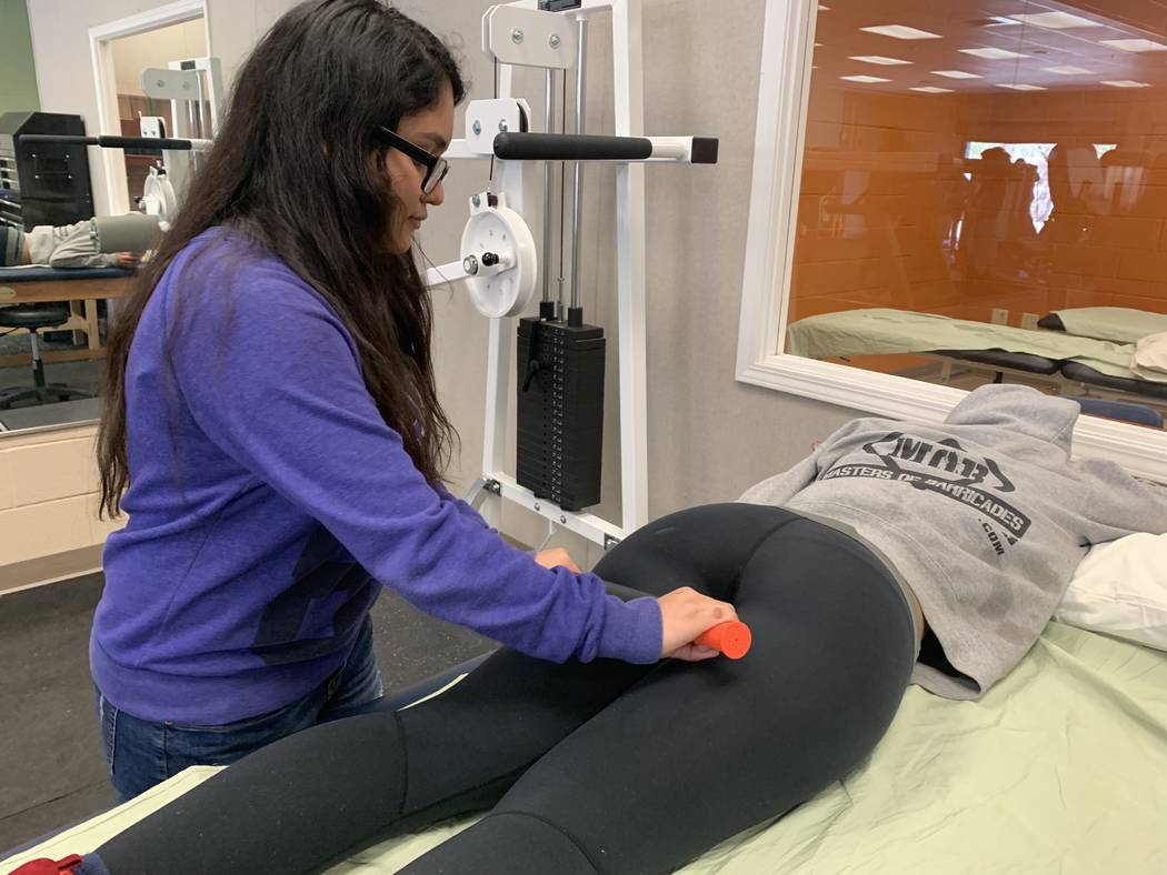 Students in the peer sports medicine class at Mojave High School act as physical therapists, tr ...
