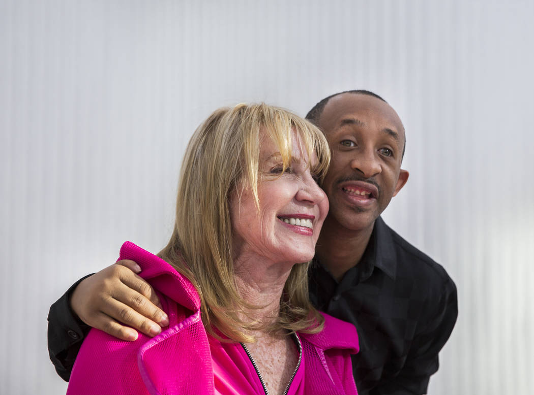 Author Linda Smith, left, takes a photo with Reggie Daniel during a reading and book signing f ...