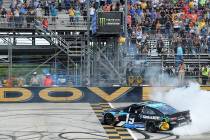 Driver Martin Truex Jr. (19) performs a burnout after winning the NASCAR Cup Series auto race, ...