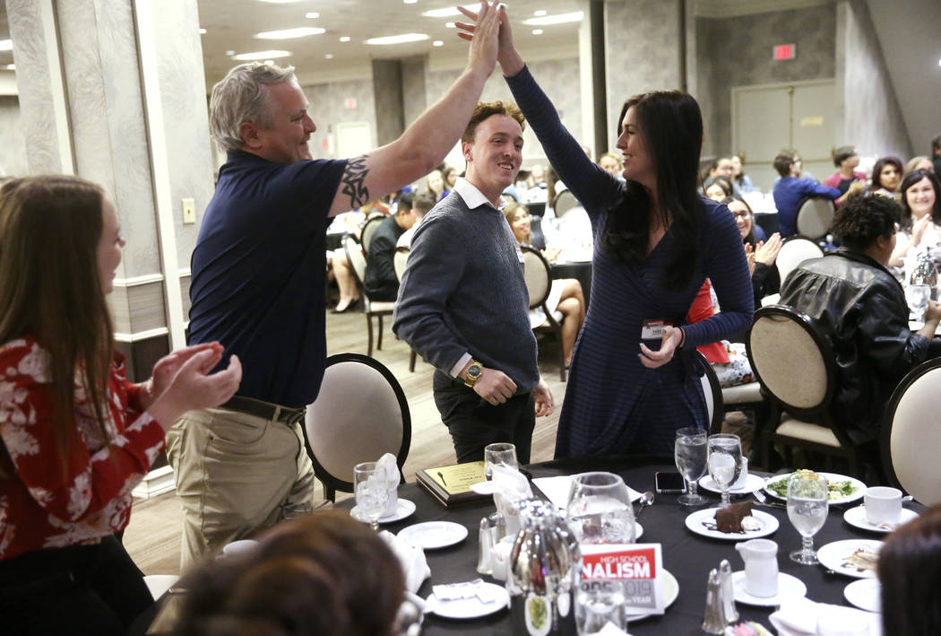 Donovan Souder, editor of the Spring Valley High School newspaper, The Grizzly Growler, center, ...