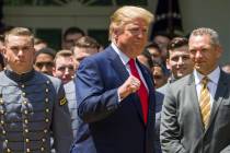 President Donald Trump pumps his fist as he departs after the presentation of the Commander-in- ...