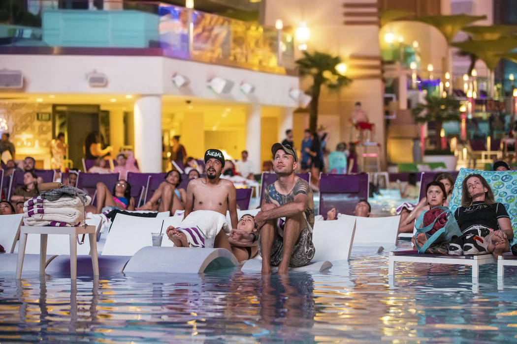 Pool goers enjoy a showing of Happy Gilmore during Dive in Movies at Boulevard Pool on Monday, ...