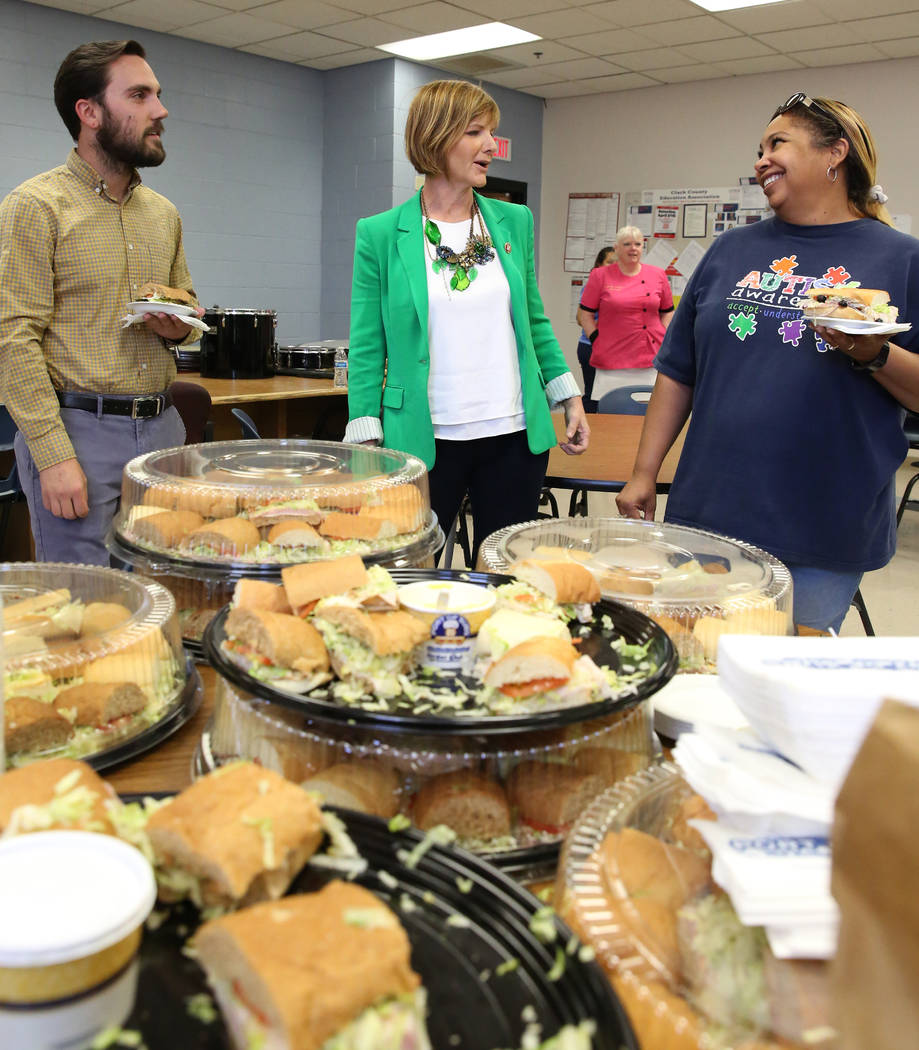 Rep. Susie Lee, D-Nev., center, chats with special education teachers, Joe Kieominski and March ...