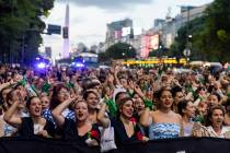 Women dressed as Eva Peron parade down the streets of Buenos Aires, Argentina, Monday, May. 6, ...