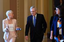 Senate Majority Leader Mitch McConnell of Ky., center, is followed by reporters as he walks to ...
