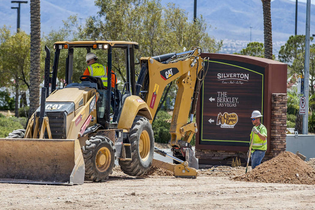 Construction workers at the site of Silverton Village, a $60 million retail and hotel project, ...