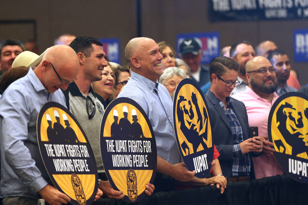 Supporters listen to Democratic presidential candidate Joe Biden speak during a campaign stop a ...