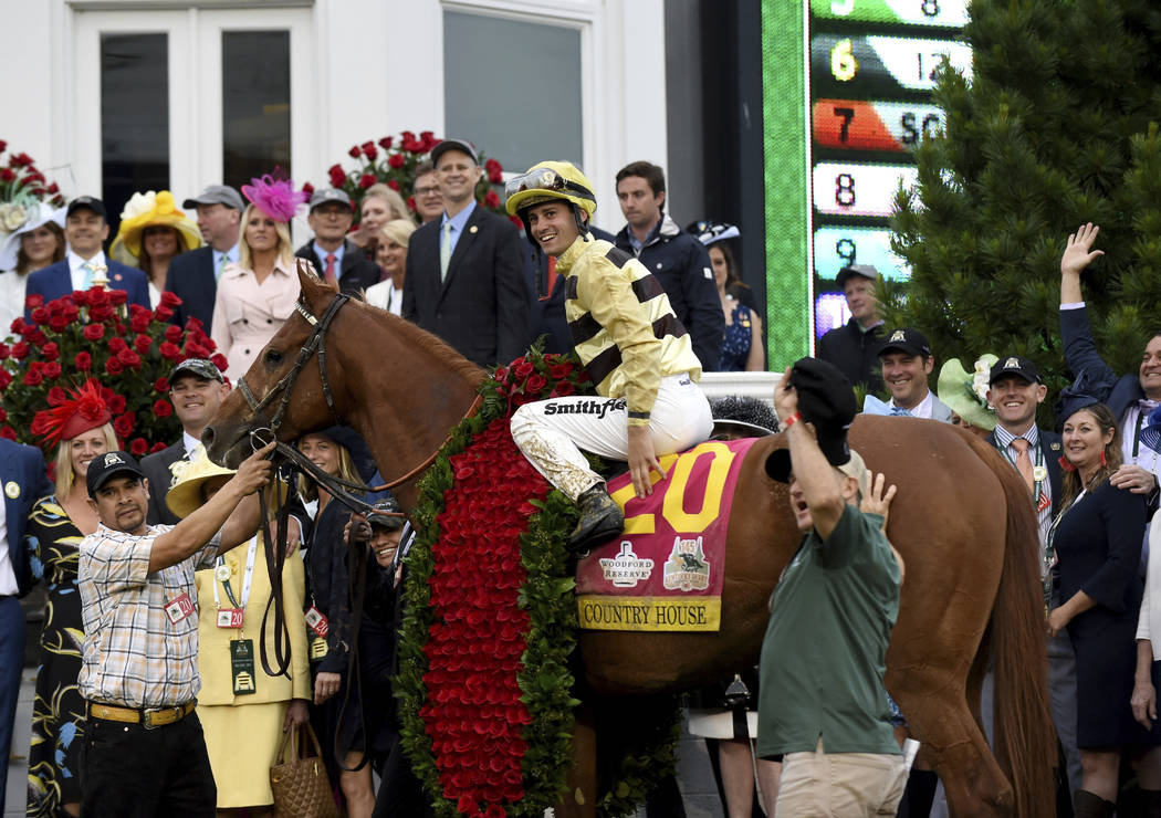 Jockey Flavien Prat celebrates with connections in the winner circle after Country House wins t ...