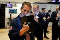 Trader Robert Charmak, left, works on the floor May 1, 2019, of the New York Stock Exchange. (A ...