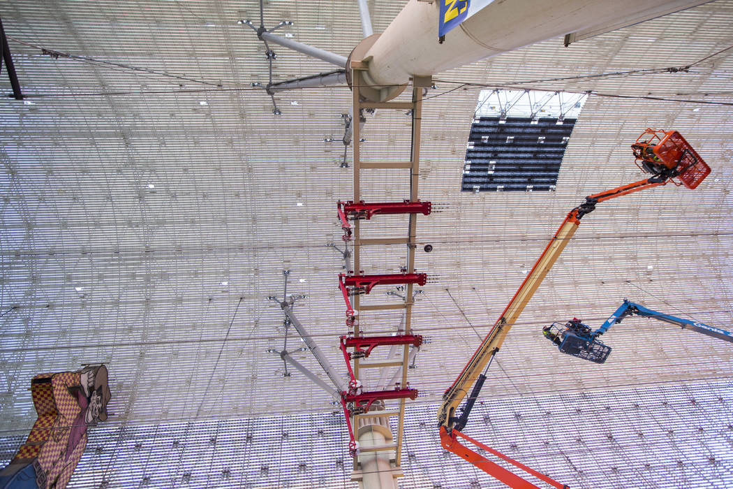 Construction workers install a new panel during the second day of renovations of the Viva Visio ...
