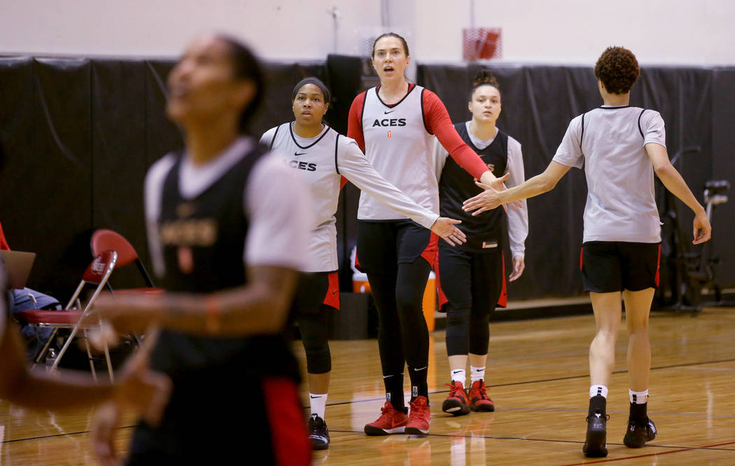 Aces center Ruth Hamblin, center, fires up teammates, from left, Alex Harden, Kayla McBride and ...