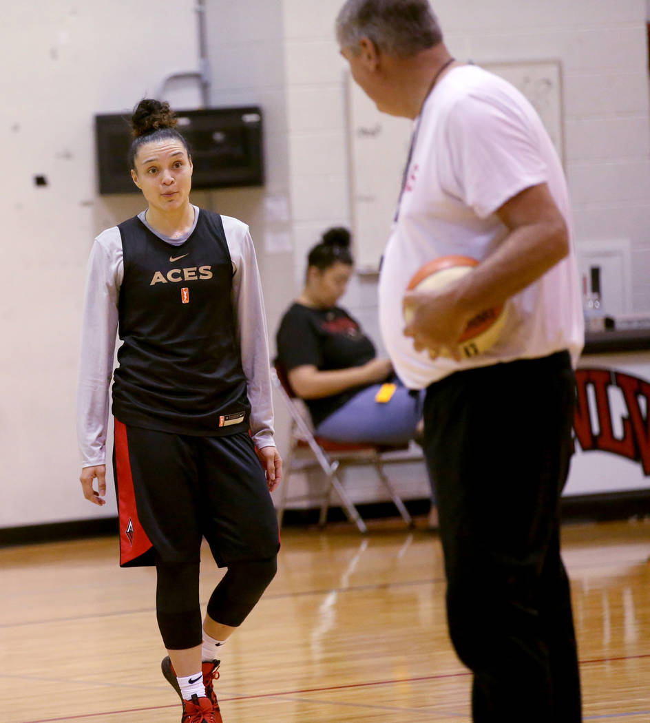 Las Vegas Aces guard Kayla McBride (21) gets instruction from coach Bill Laimbeer during practi ...