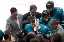 San Jose Sharks center Joe Pavelski, bottom center, is helped off the ice during the third peri ...